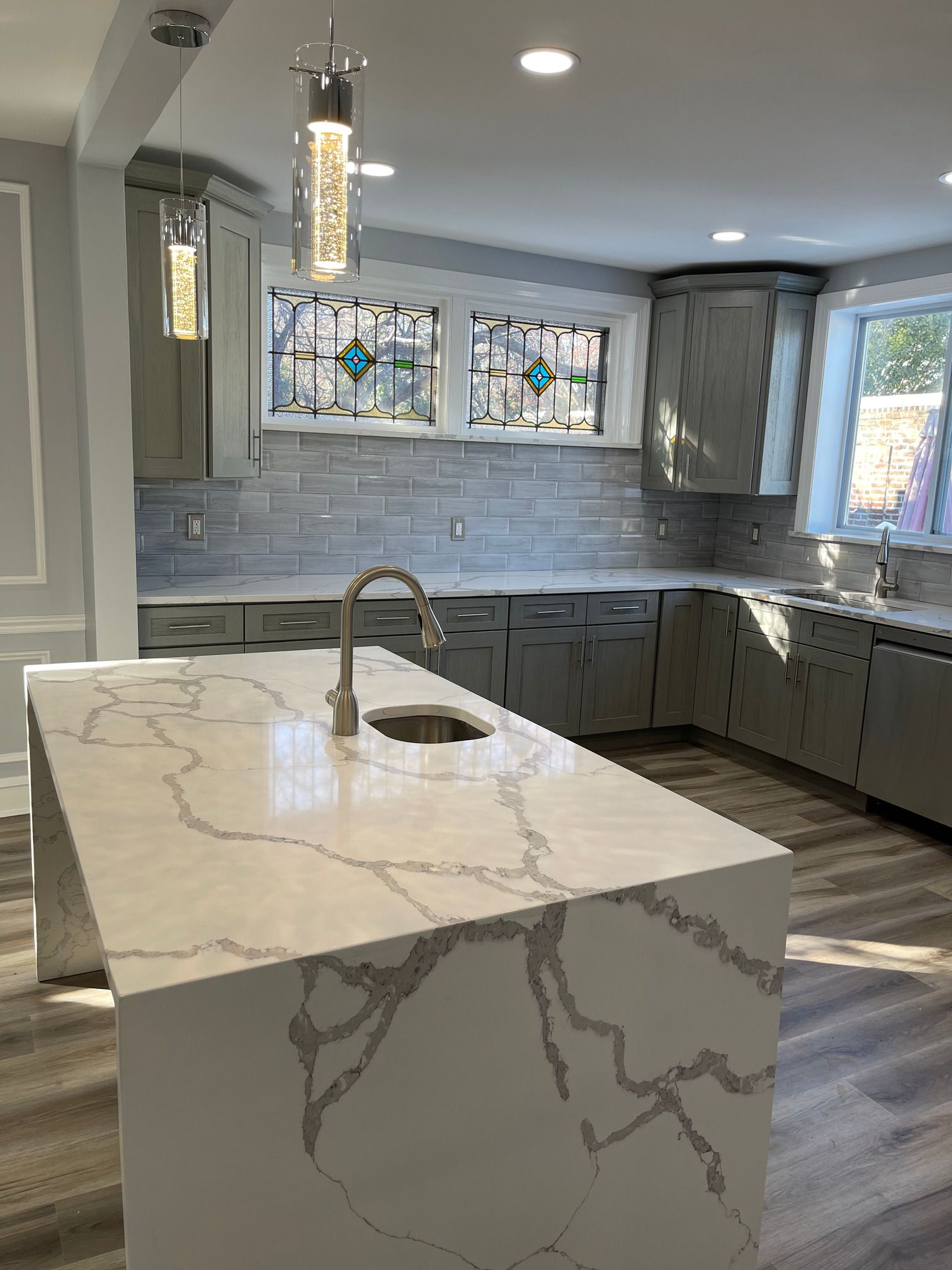 A kitchen with a large island and a sink.
