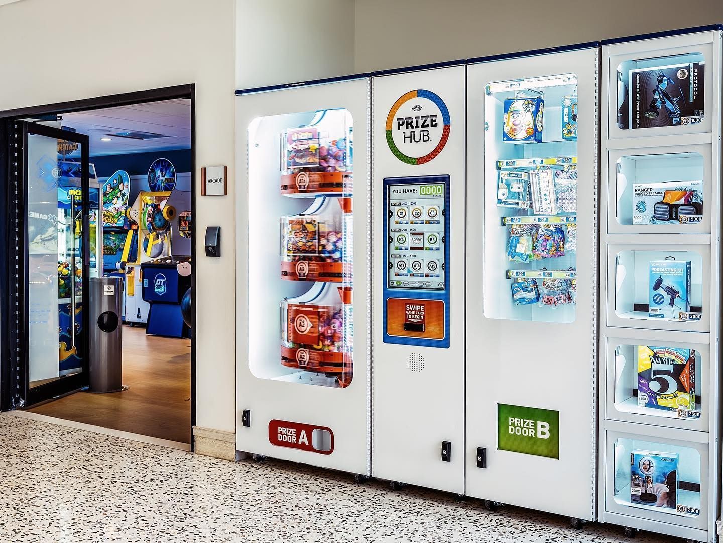 a vending machine filled with toys and snacks in a room