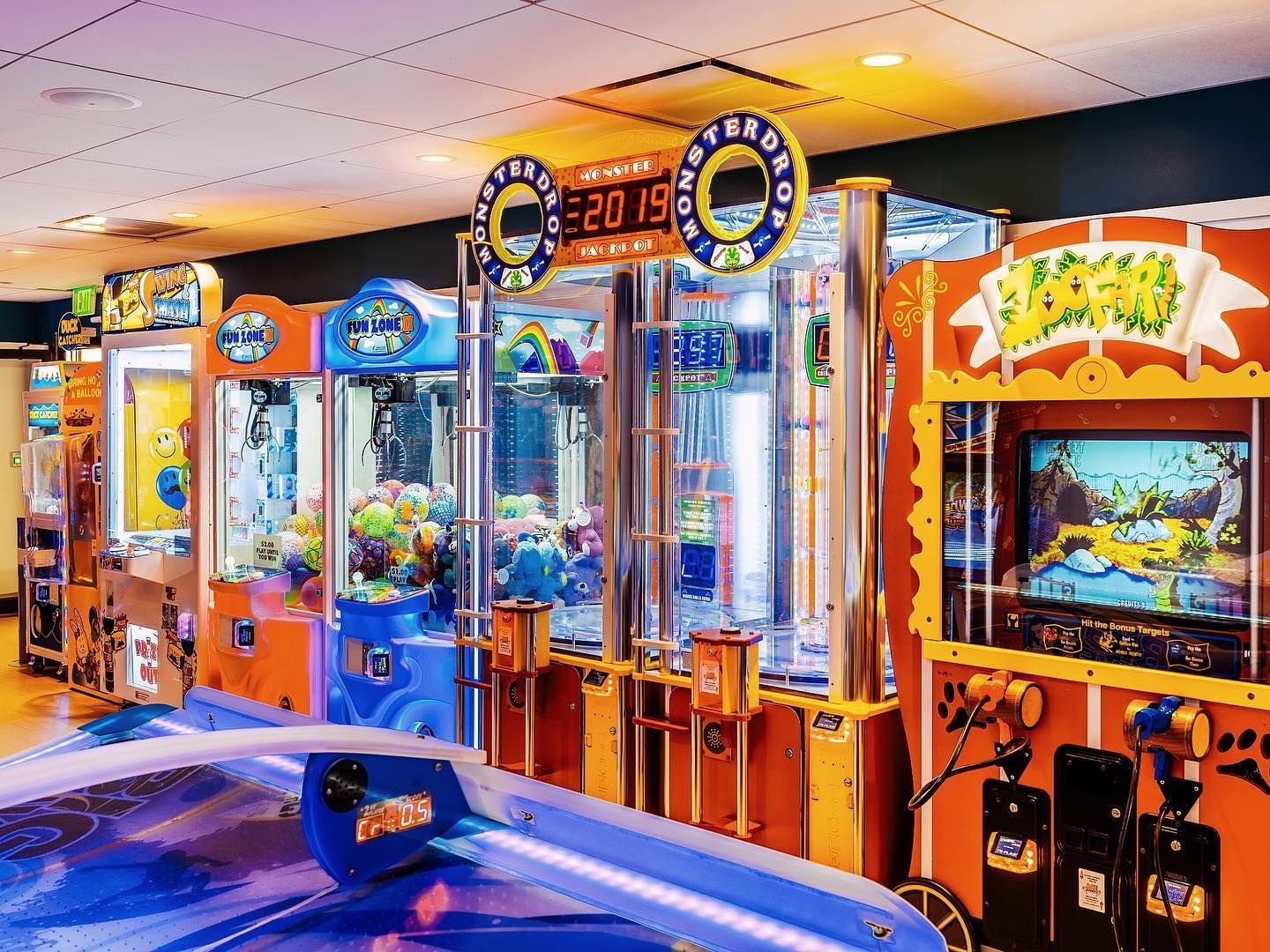 a bunch of arcade games are lined up in a room