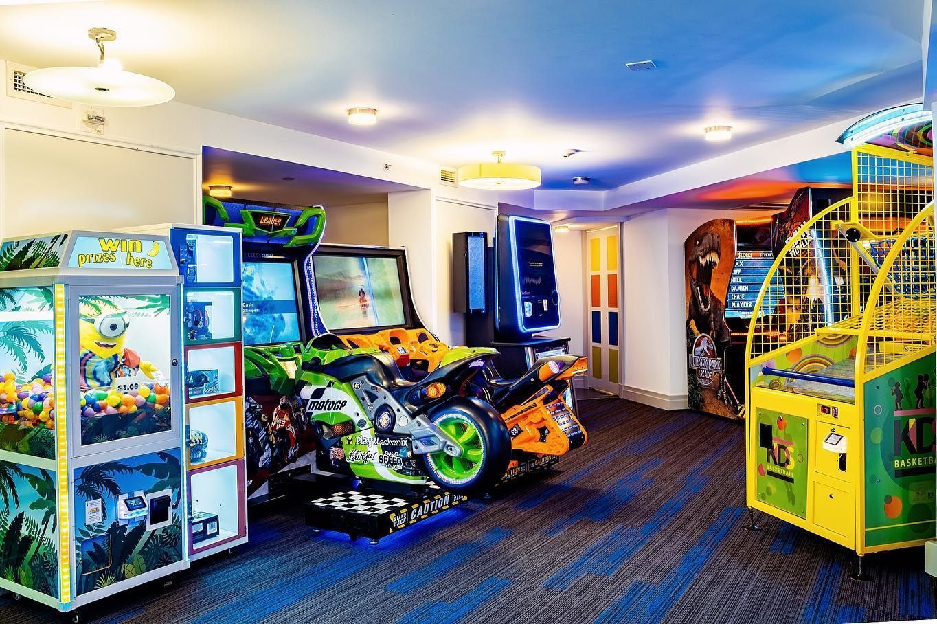 a room filled with lots of arcade games and a motorcycle