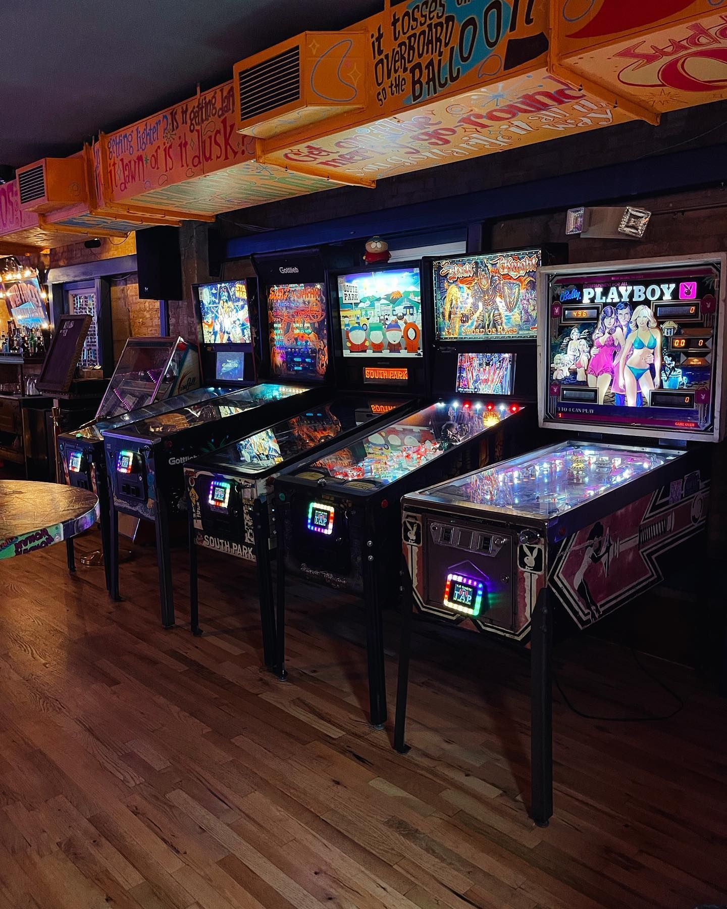 a row of pinball machines are lined up in a room