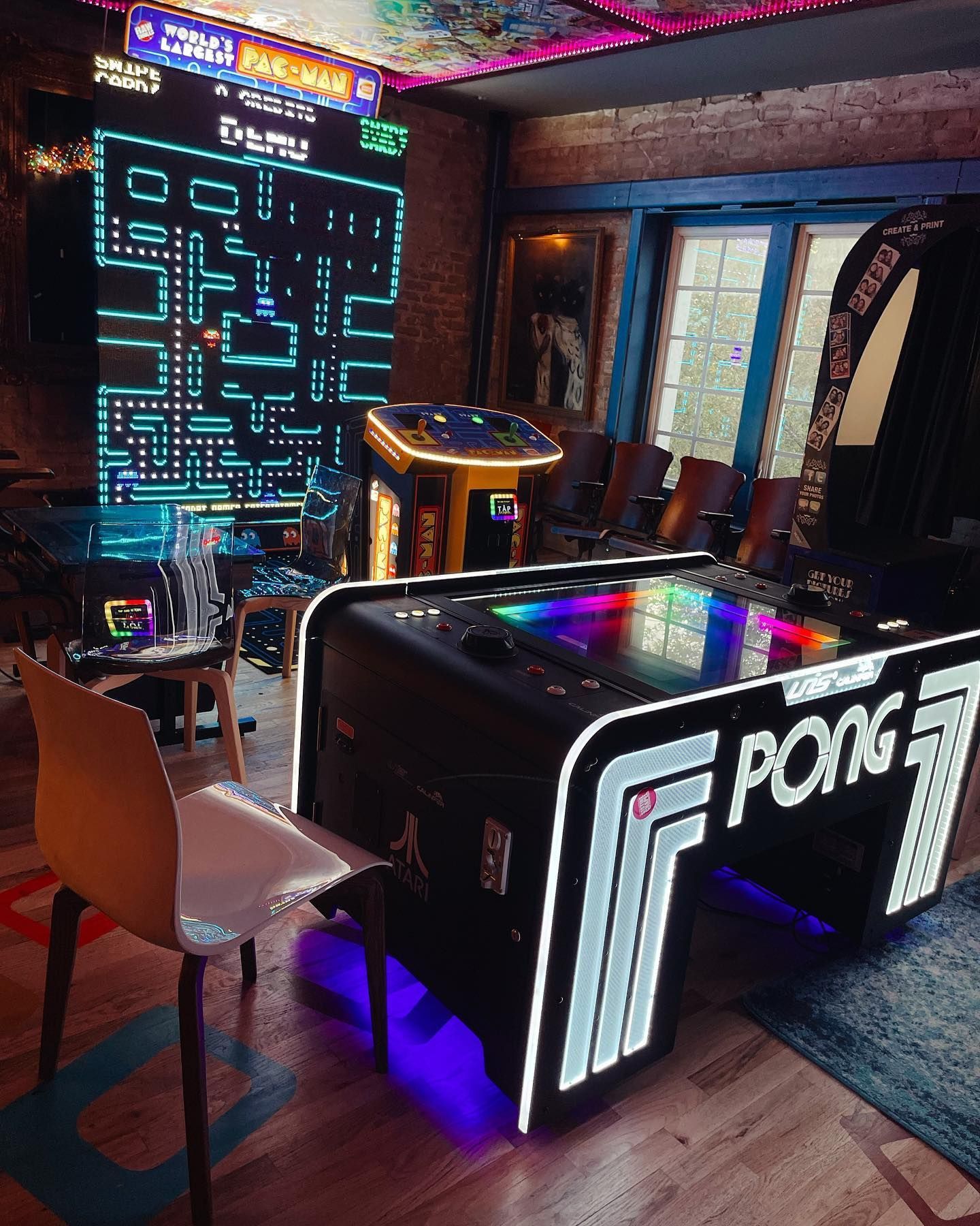 a room with a pong machine and a PAC-MAN machine