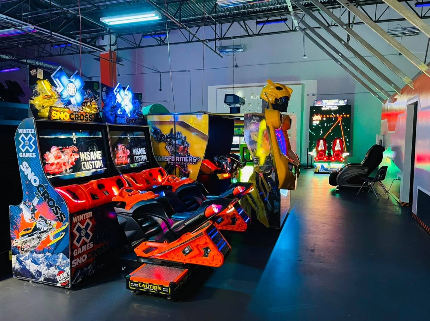 a bunch of arcade games are lined up in a room
