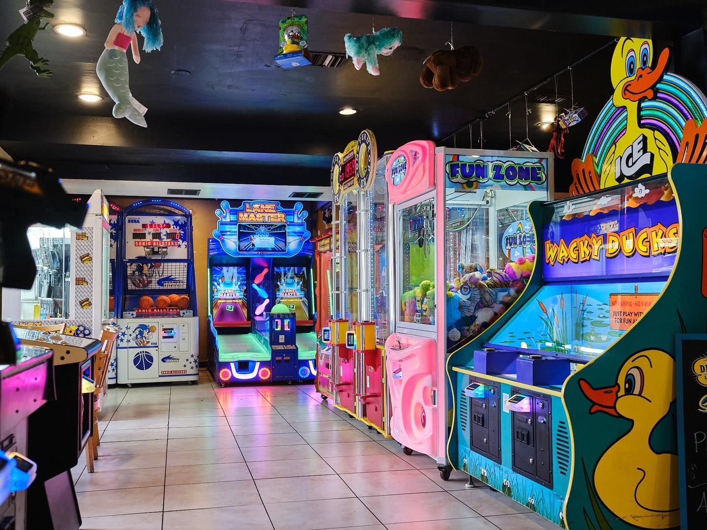 a bunch of arcade games are lined up in a room