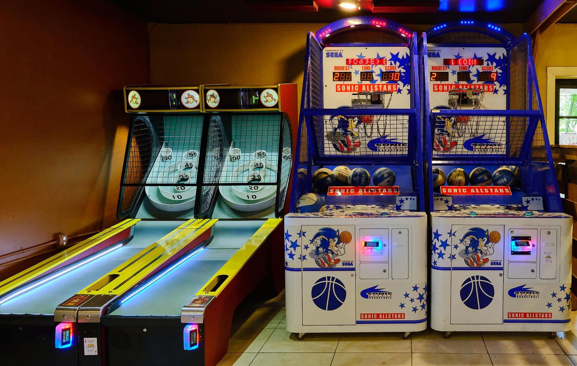a bowling alley and a basketball game in an arcade