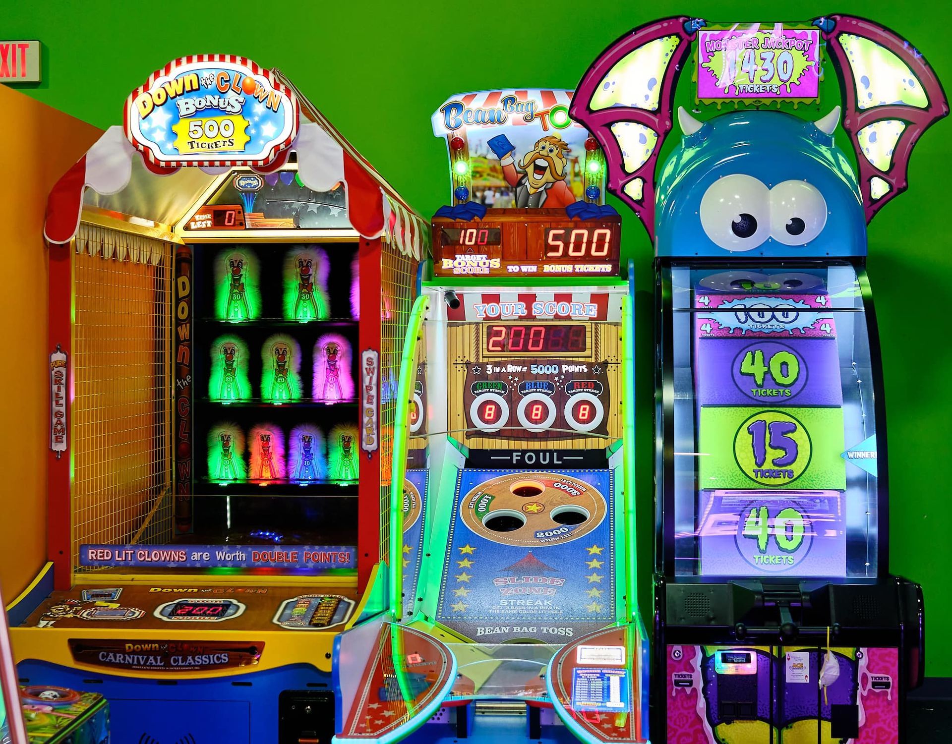 a bunch of arcade games are lined up on a green background