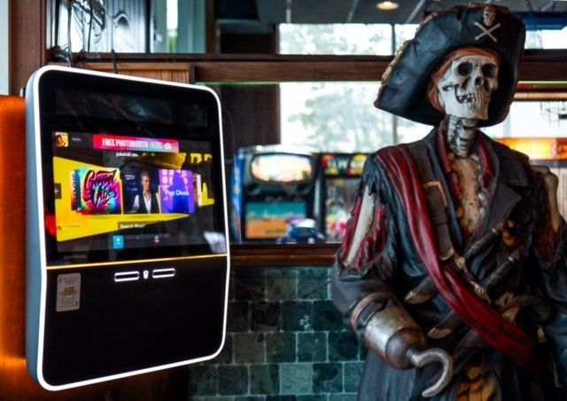 two pool tables are in a room with arcade games