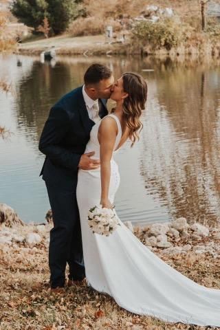 Wedding couple kissing on the lake