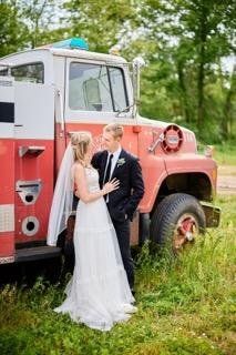 Bride and groom next to a truck
