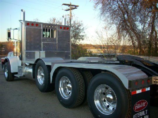 a peterbilt semi truck is parked on the side of the road