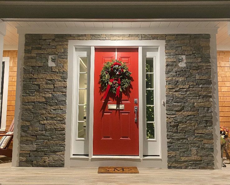 A red door with a christmas wreath on it