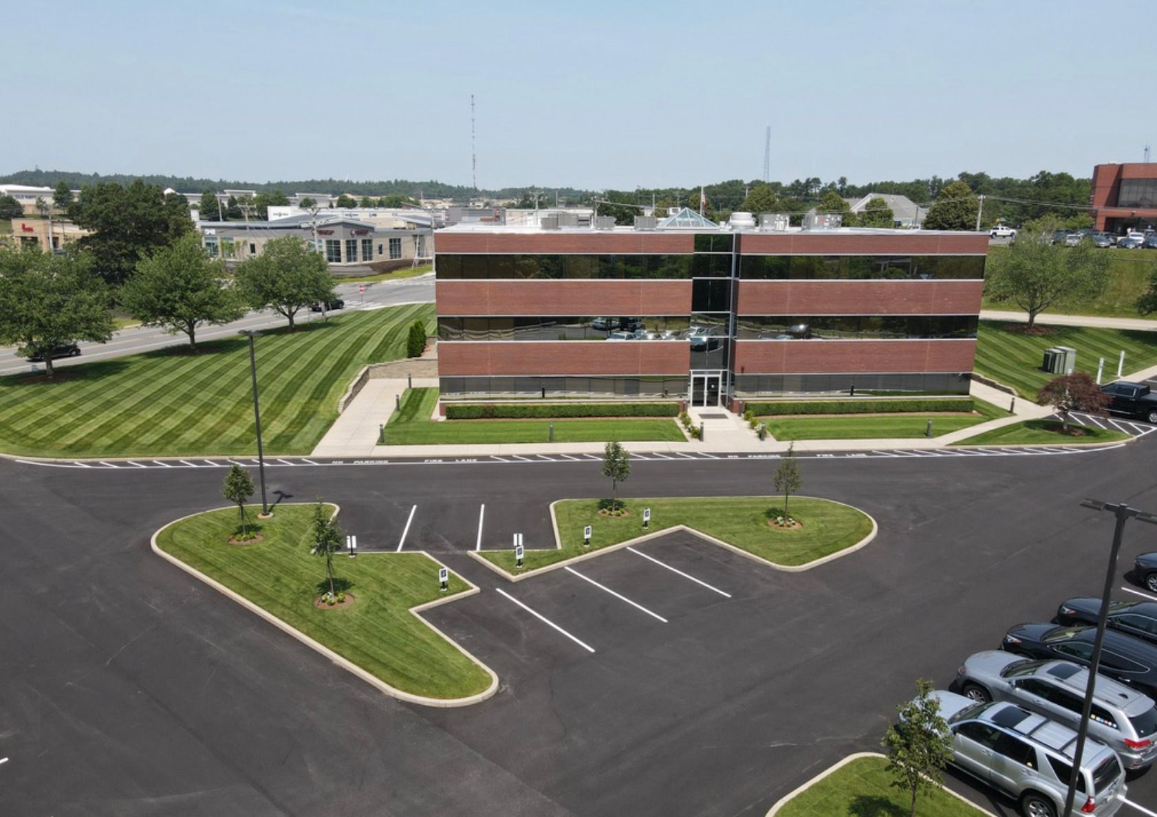A large brick building with a parking lot in front of it