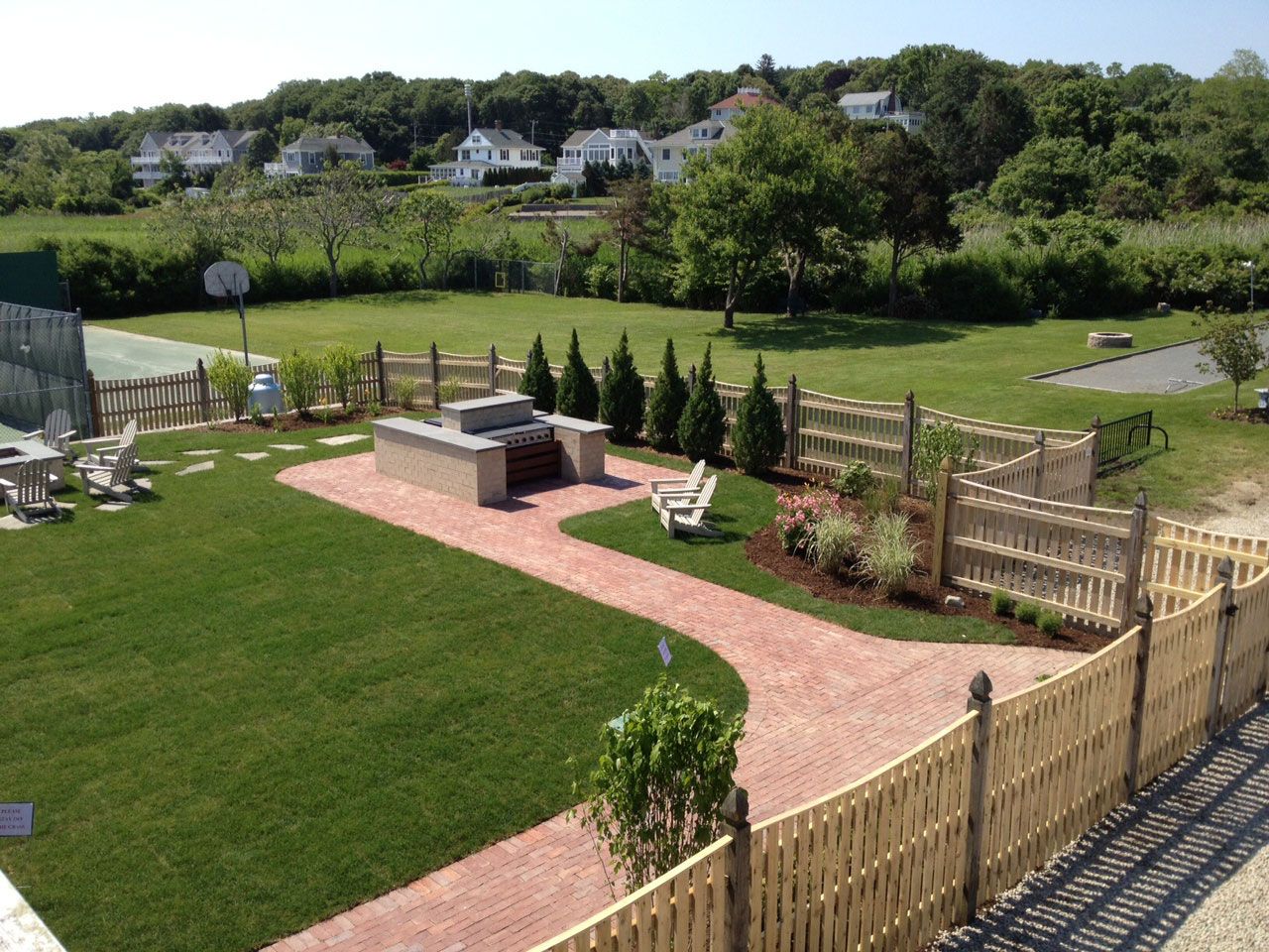 An aerial view of a backyard with a wooden fence