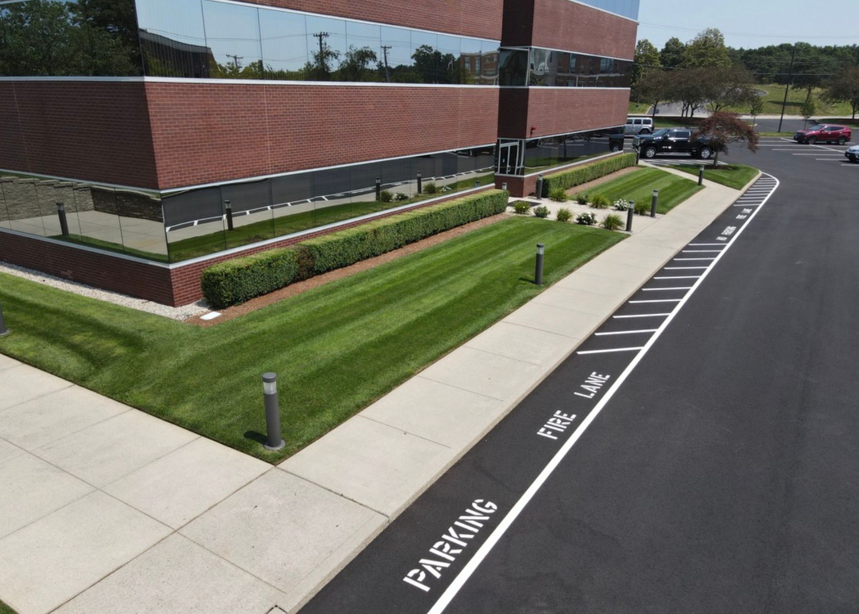 An aerial view of a parking lot in front of a building