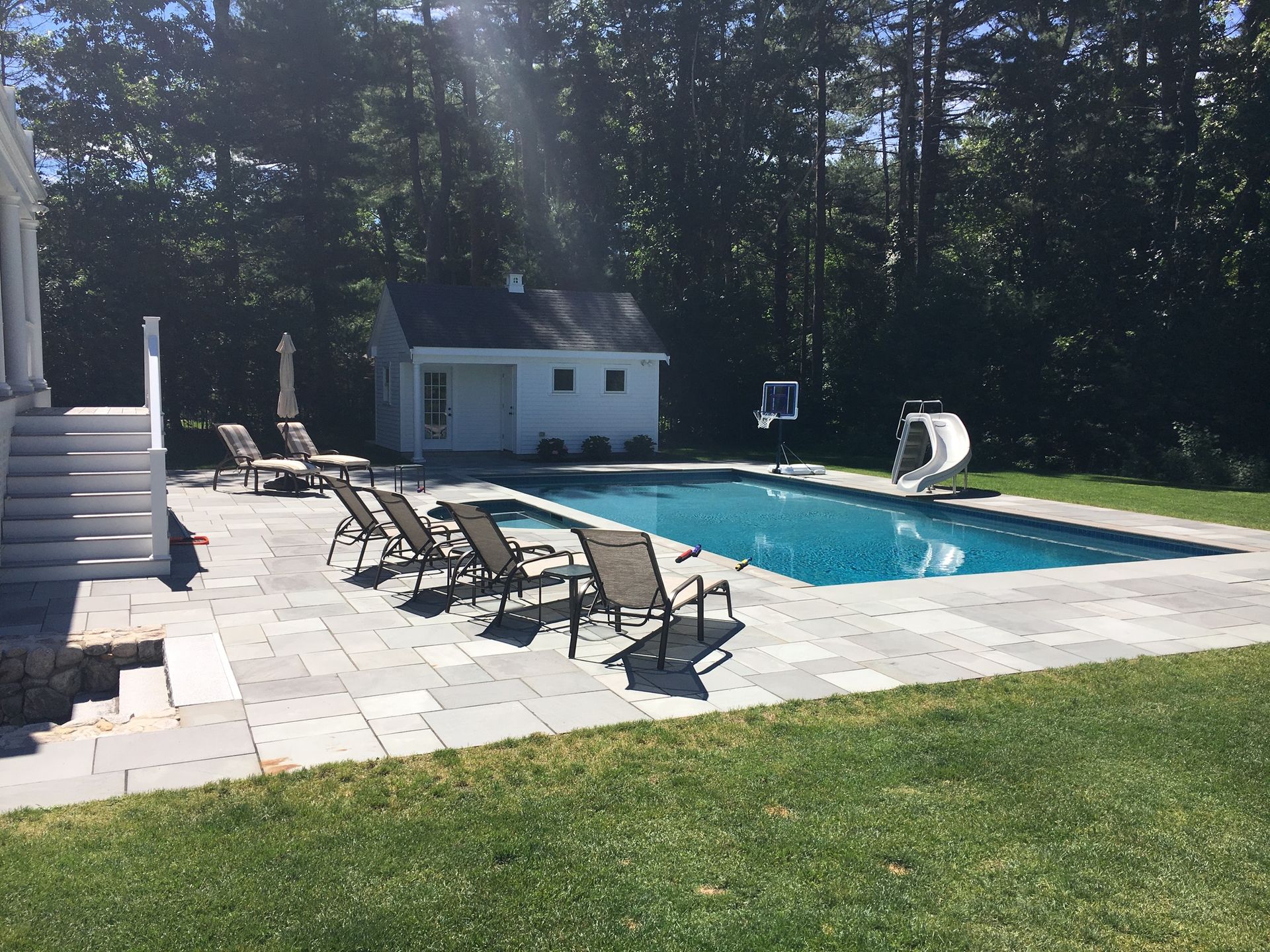 A large swimming pool surrounded by chairs