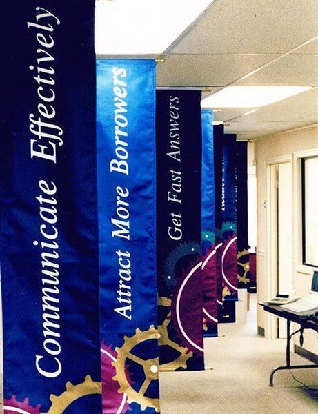 Banners in a hallway, navy blue with white text and gear graphics: