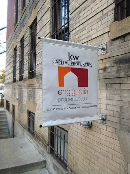 Banner for KW Capital Properties with the Eng Garcia Properties logo on a brick building.