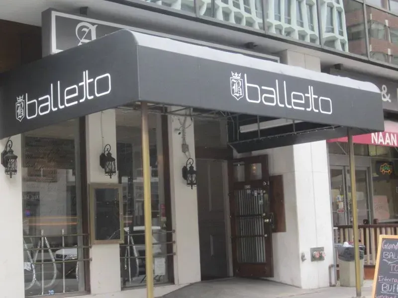 Balletto restaurant entrance with a black awning and white lettering.