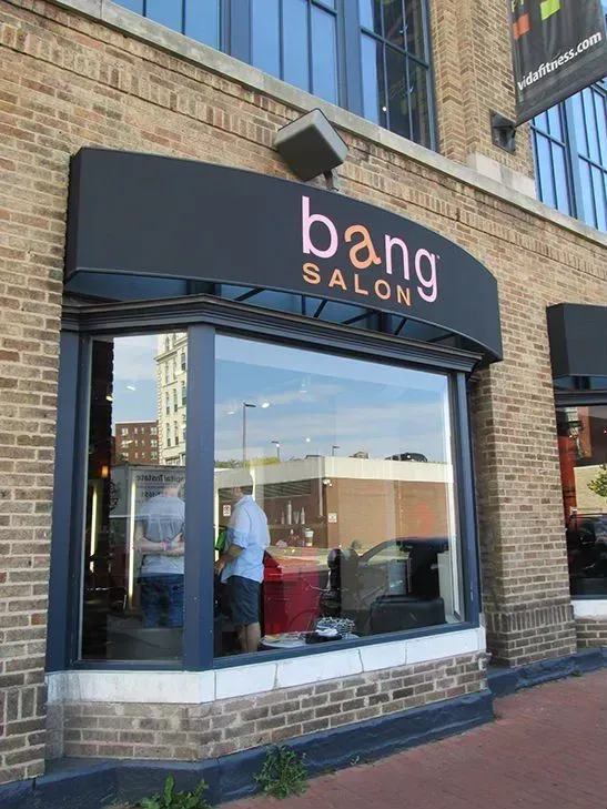 Bang Salon storefront with a black awning and large window.
