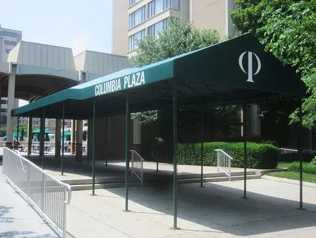 Green awning over entrance to Columbia Plaza building. White text and logo are visible.