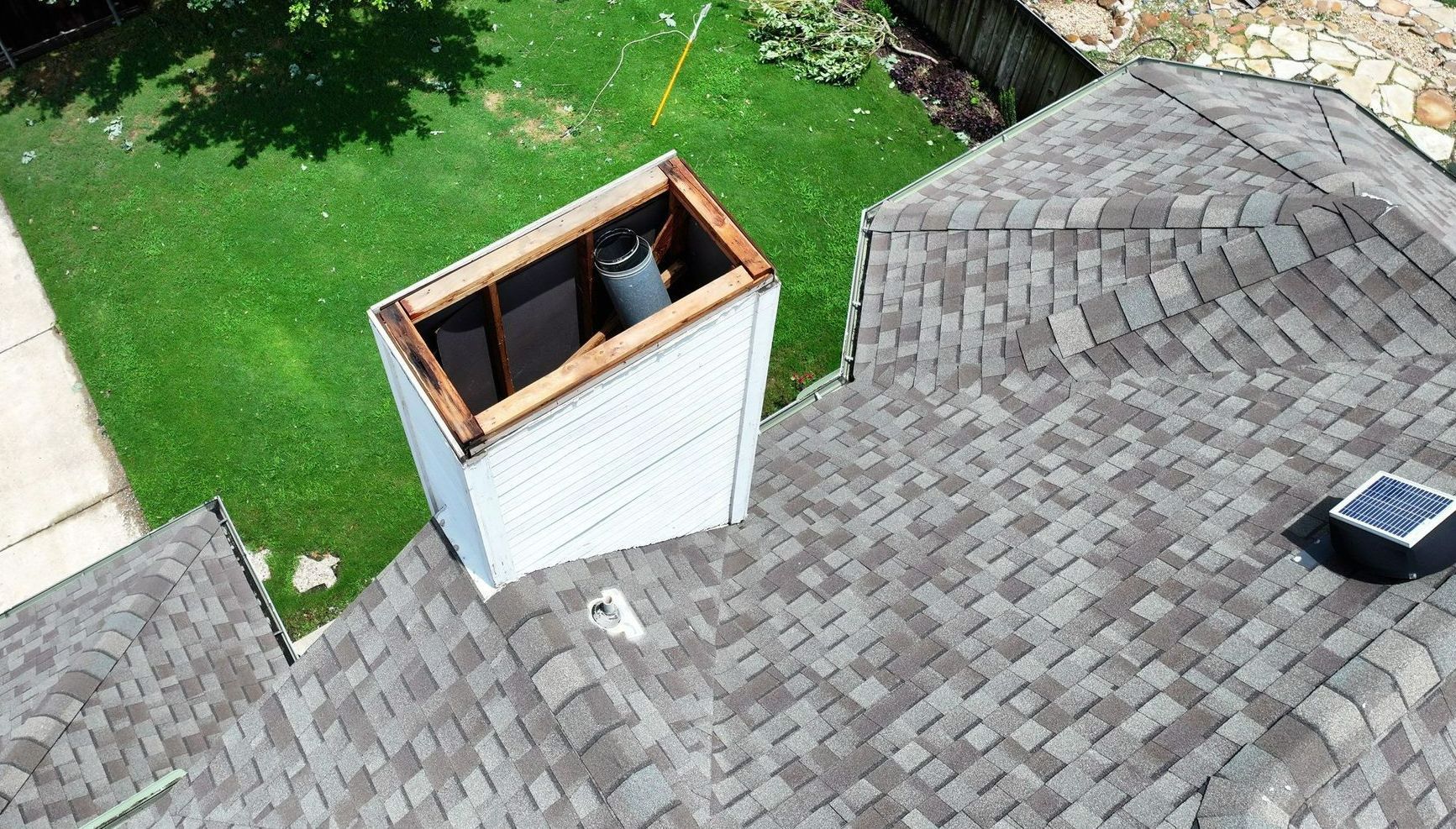 Home in Carrollton Texas that had wind damage to the chimney, missing a piece from storms in the dfw metroplex. The home needed an area of the roof replaced, done by Becker Roofing and Exteriors. 