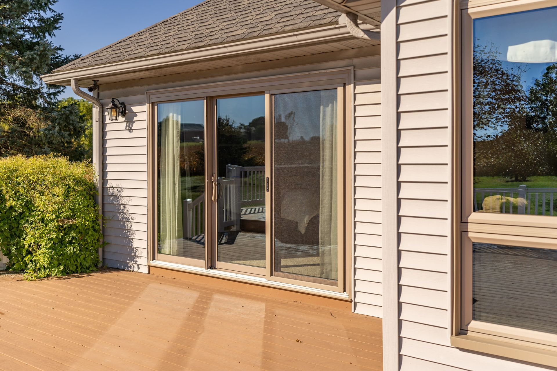 A house with a patio and sliding glass doors