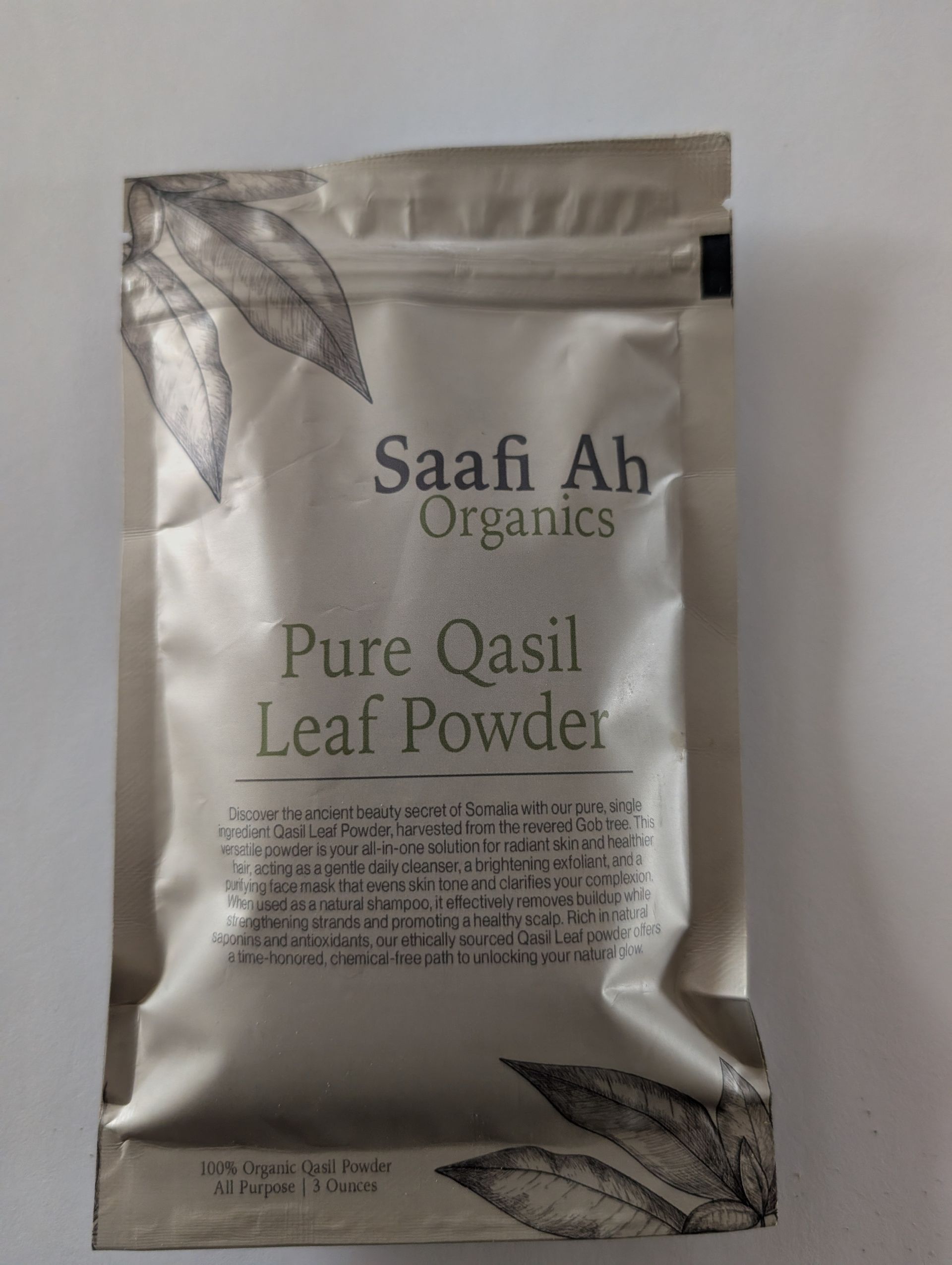 A silver pouch of Saafi Ah Organics Pure Qasil Leaf Powder, featuring botanical leaf illustrations.