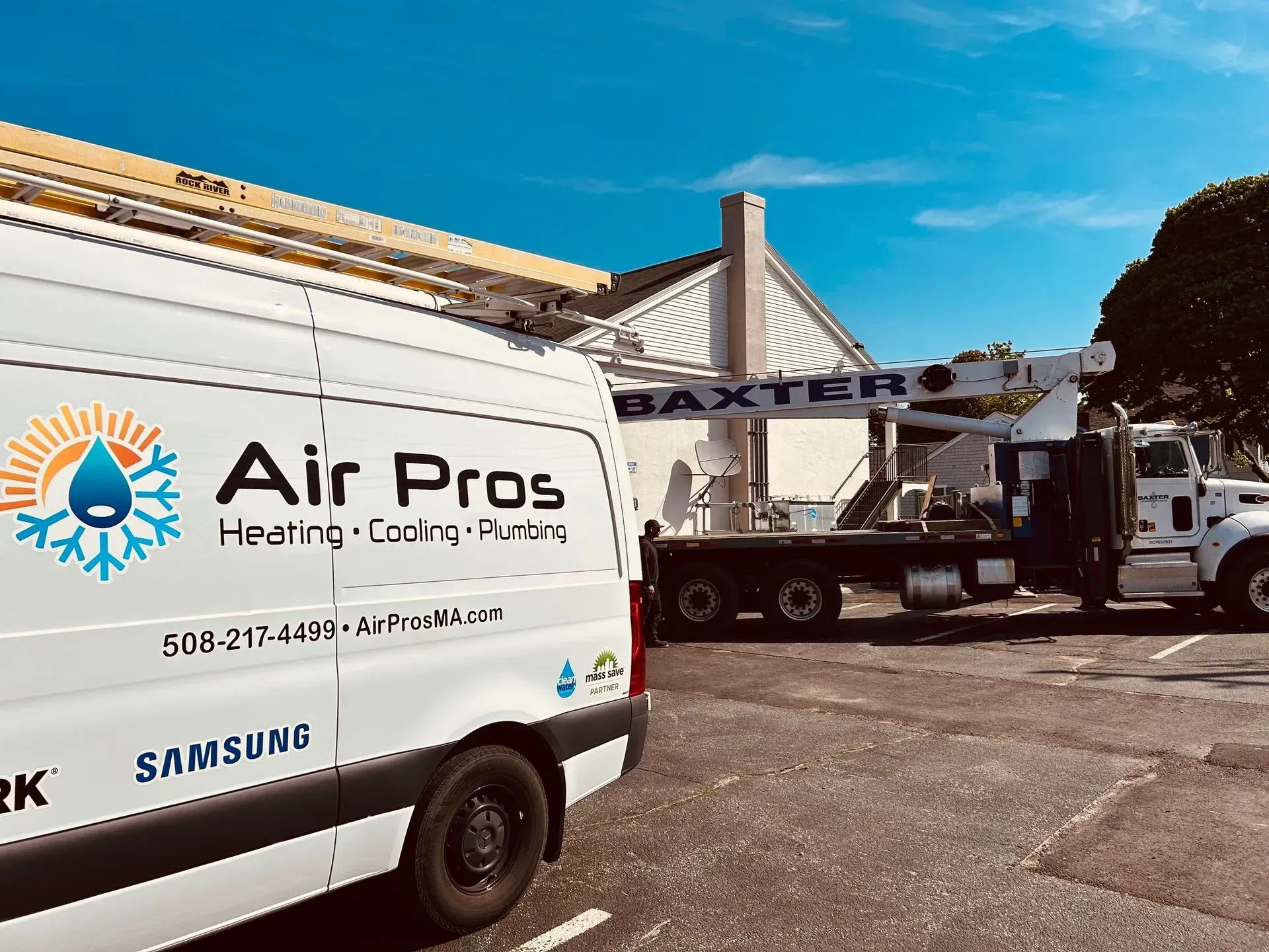 Air Pros van and Baxter truck at a residential building on a sunny day.