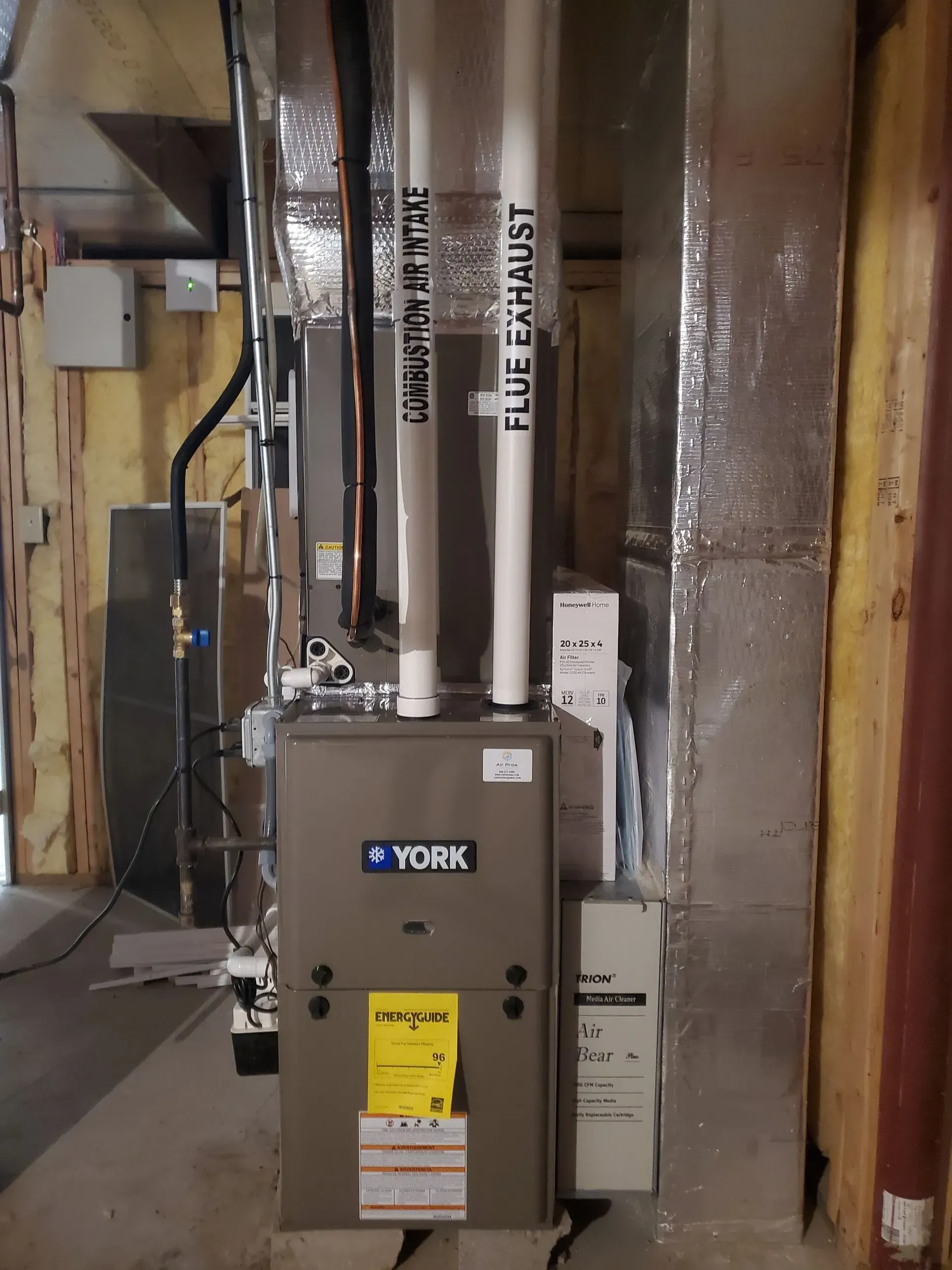 York furnace with flue exhaust and ductwork in a basement setting.