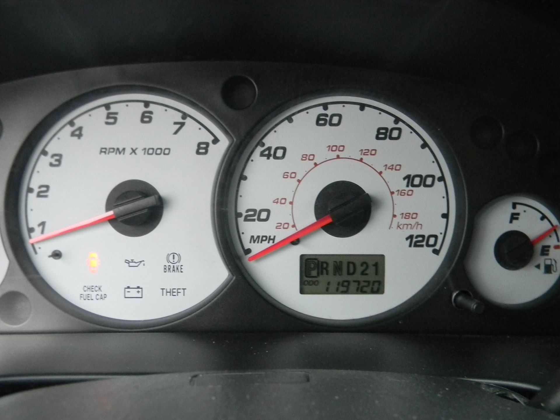 Car dashboard center console with radio, climate controls, and vents above the gear shift