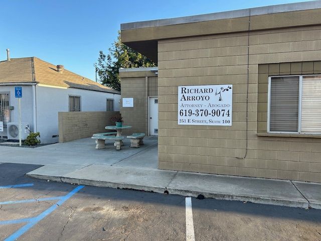 A sign on the side of a building says Richard Arroyo