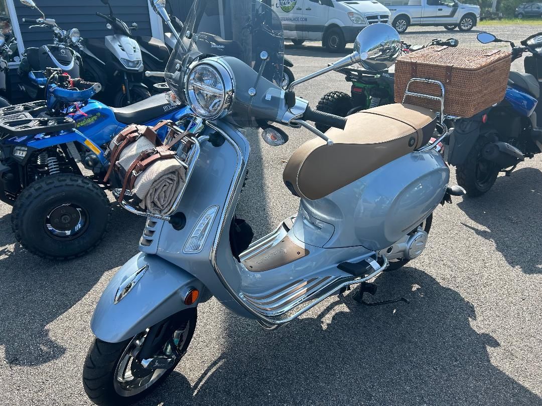 A scooter is parked in a parking lot next to other scooters.