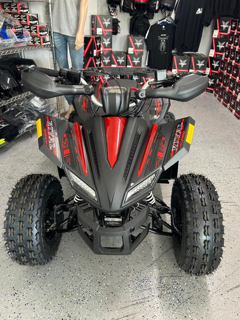 A black and red atv is parked in a store.