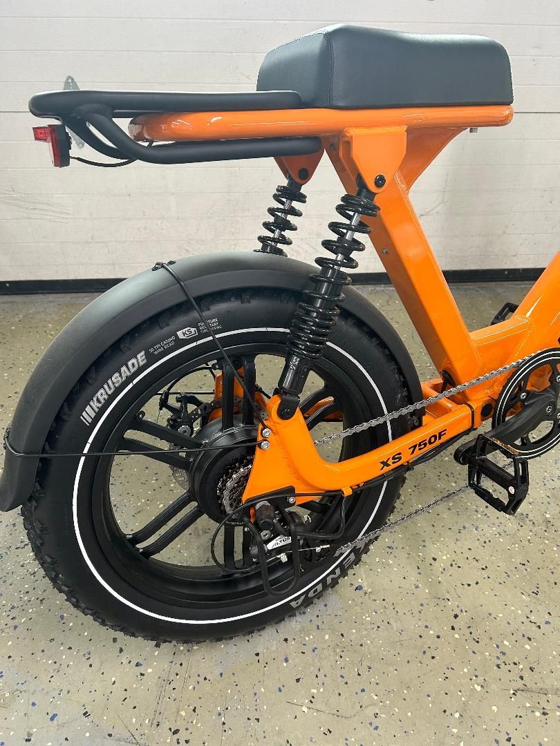 A close up of the back of an orange bicycle