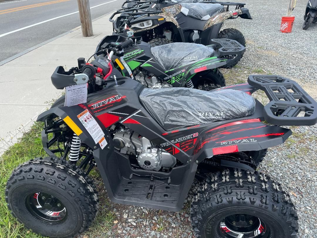 A row of atvs are parked on the side of the road.