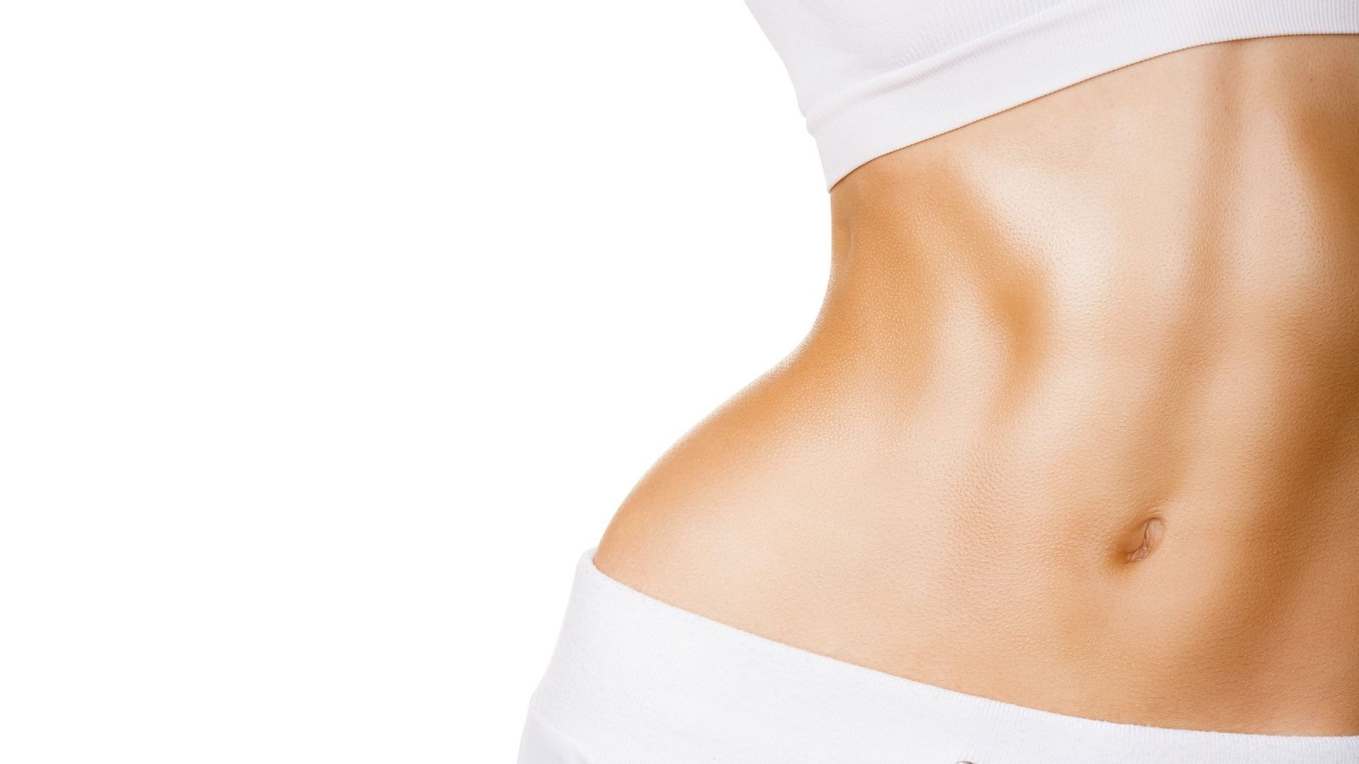 A close up of a woman 's stomach in white underwear on a white background.
