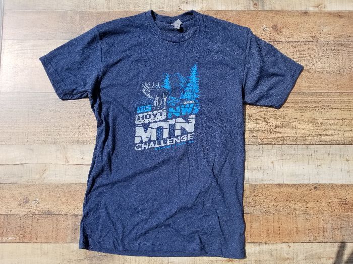 a blue t-shirt is sitting on a wooden table