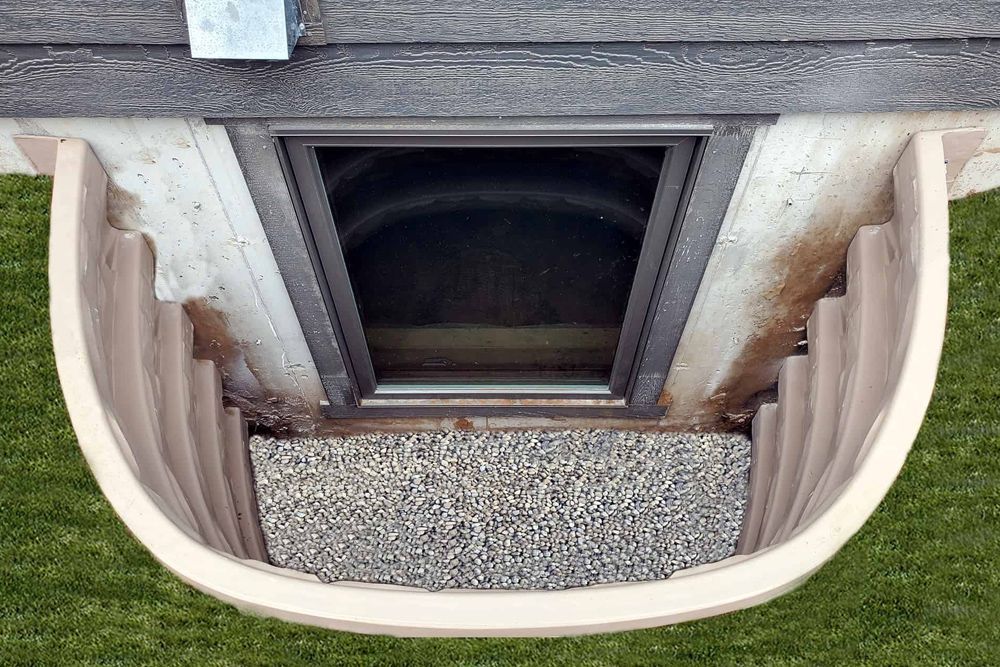 An aerial view of a basement window with stairs leading up to it.