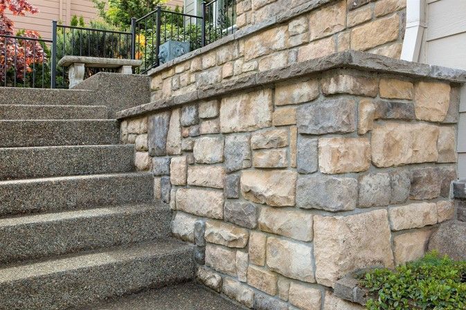 A stone wall with stairs leading up to it.