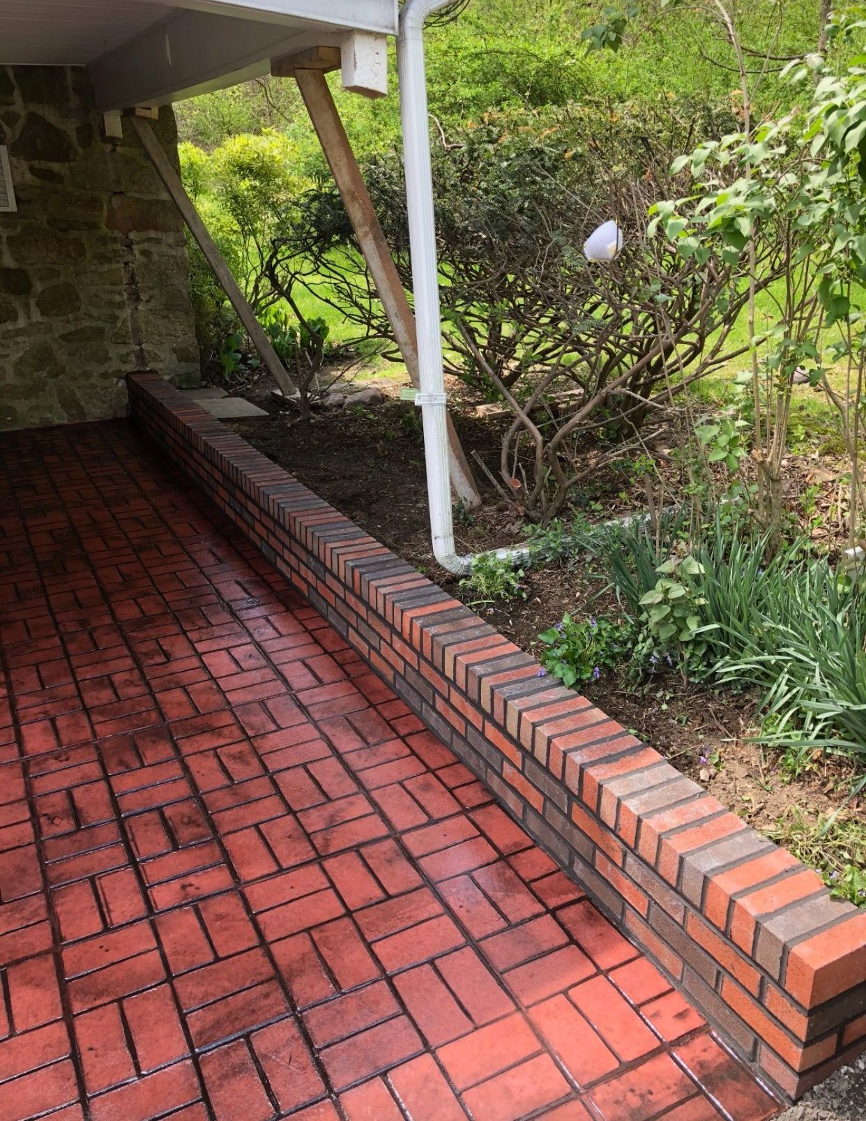 A picture of a brick walkway leading to a house.