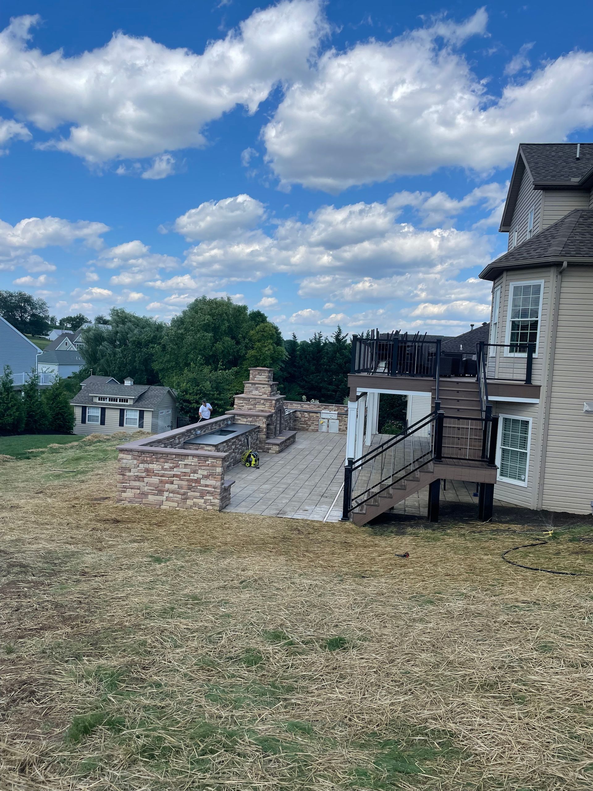 A house with a deck and stairs in the backyard.