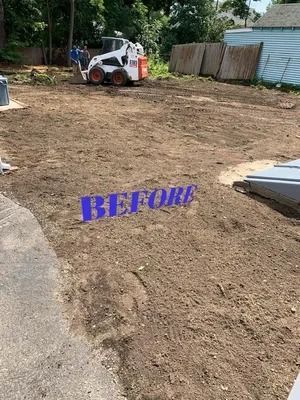 Bare dirt yard with a skid-steer loader, fence, and the word “BEFORE” in purple text.