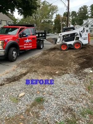 Red tow truck lifting a white skid steer from a muddy driveway, labeled “BEFORE.”