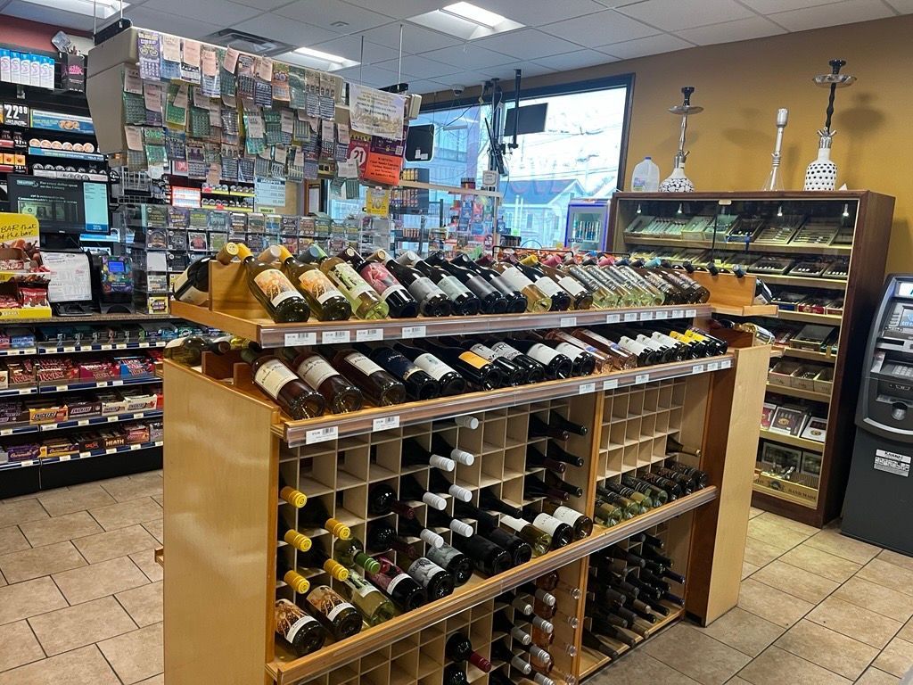 A store filled with lots of wine bottles on shelves.