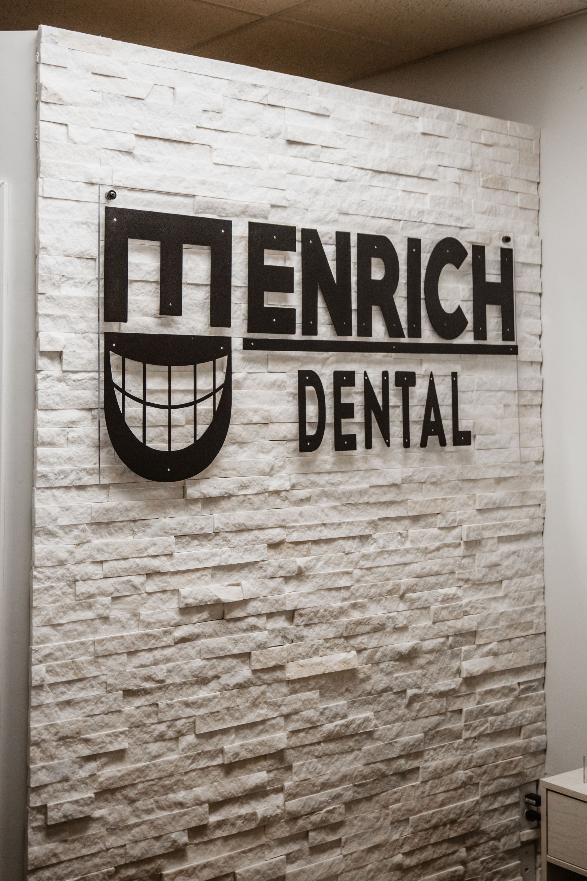 There is a mural on the wall of a dental office with a dog on it.