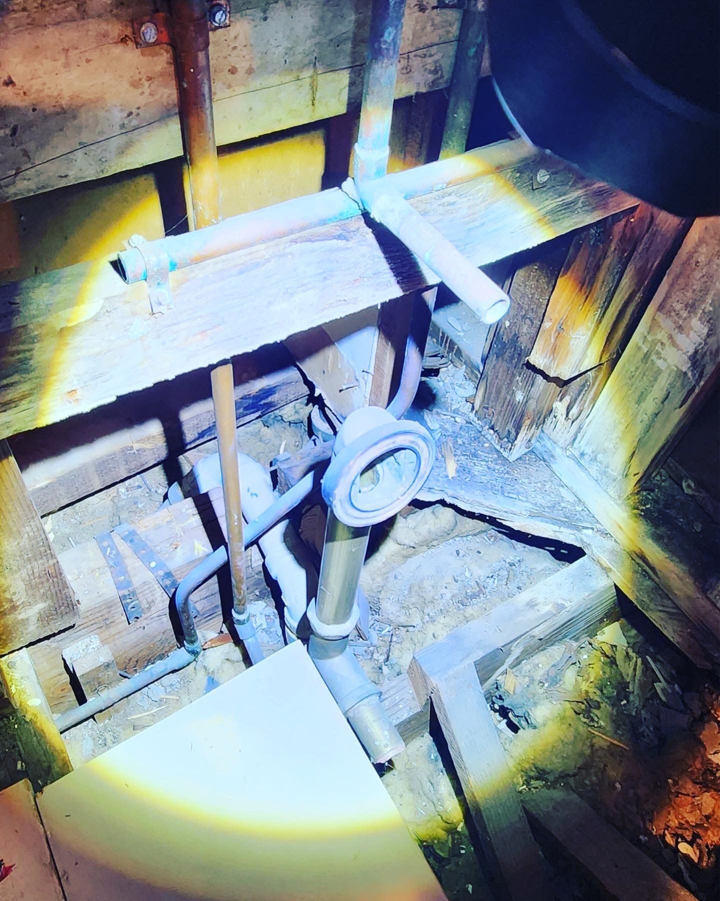 a light is shining on a pipe in a wooden room