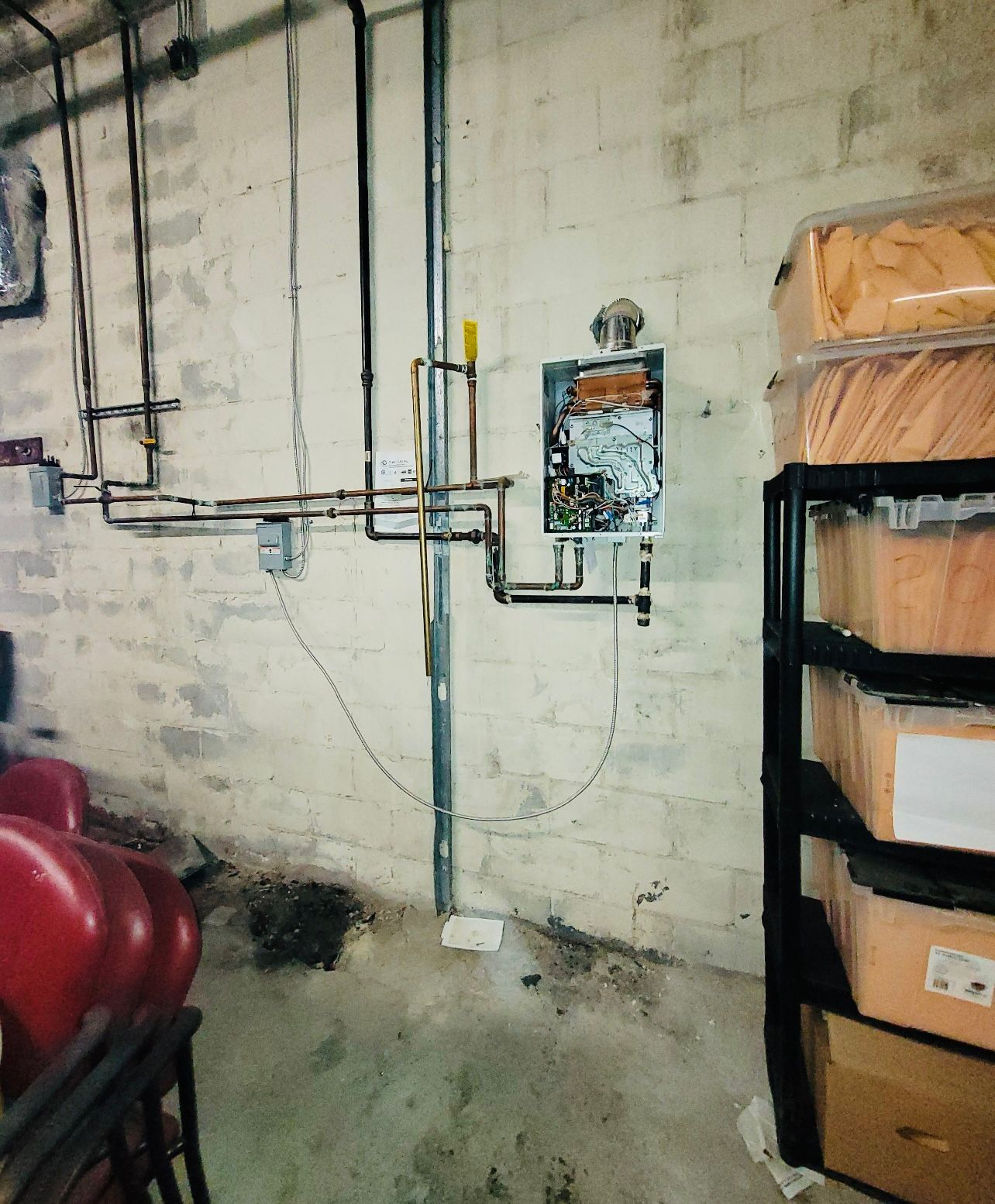 a room with boxes on a shelf and a clock on the wall