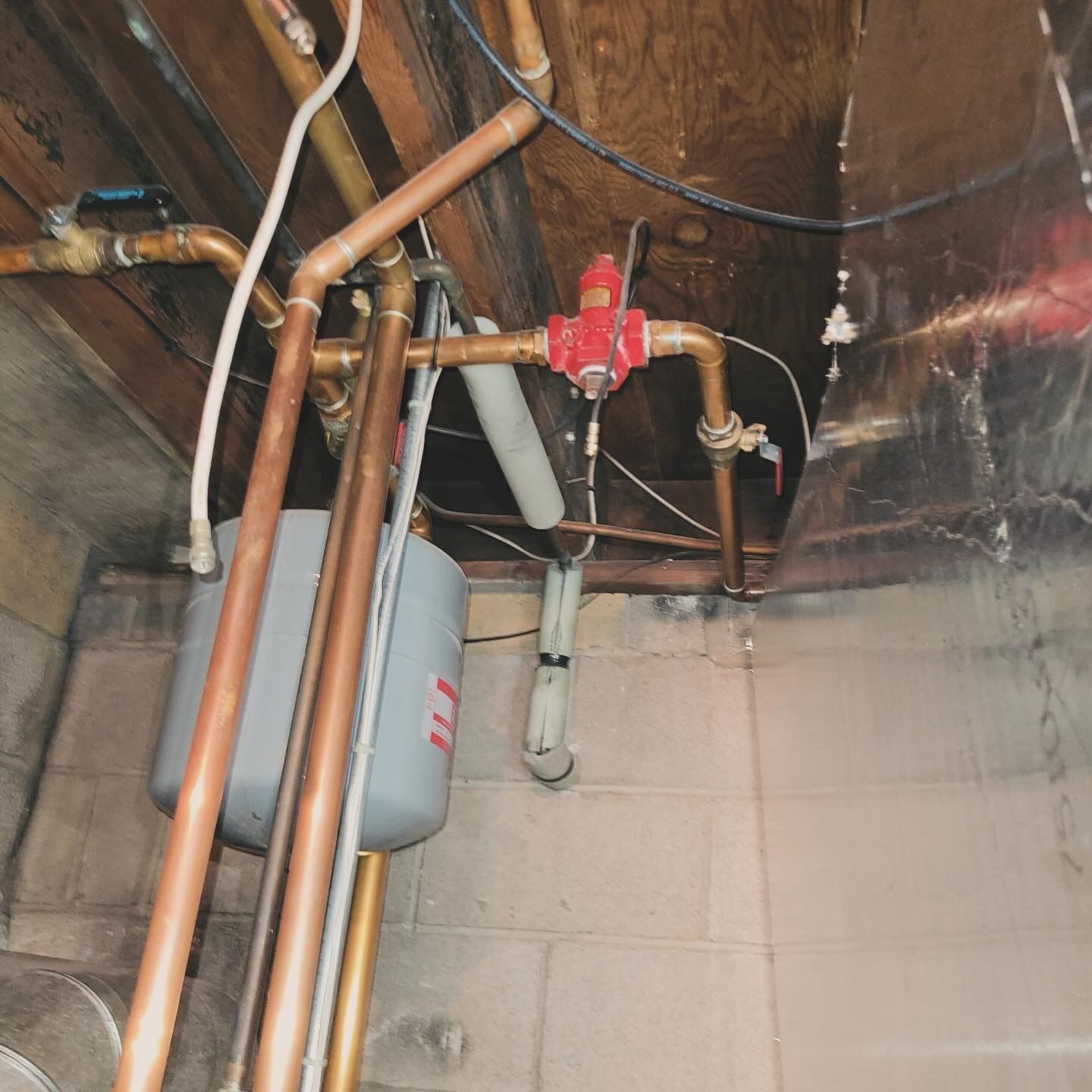 copper pipes are connected to a gray tank