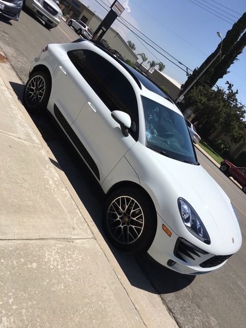 A white car is parked on the side of the road.