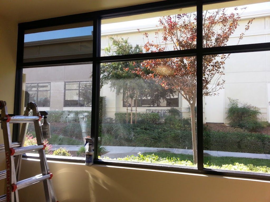 A ladder is leaning against a window in a room.